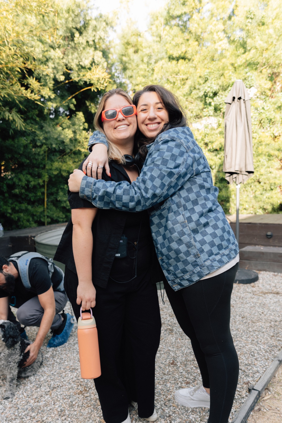 Two crew members sharing a hug on set