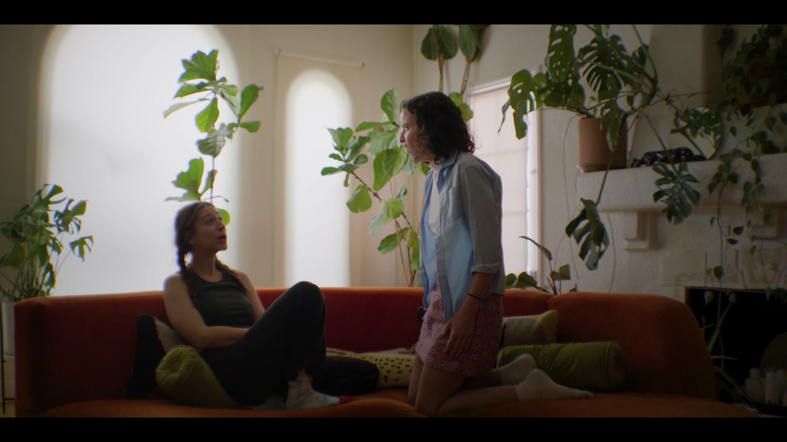 Rowan and Andy talking by the red sofa